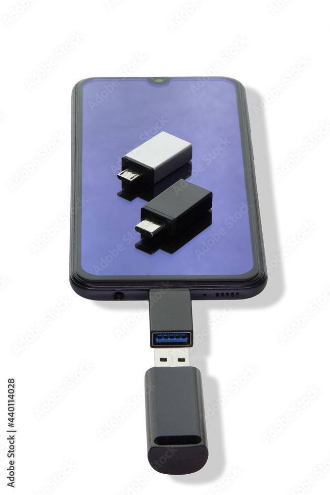 Isolated on a white background phone or smartphone with USB OTG data transfer connected to a USB flash drive Isolated on a white background phone or smartphone with USB OTG data transfer connected to a USB flash drive
