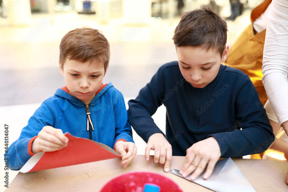 Two children make paper crafts Two children make paper crafts