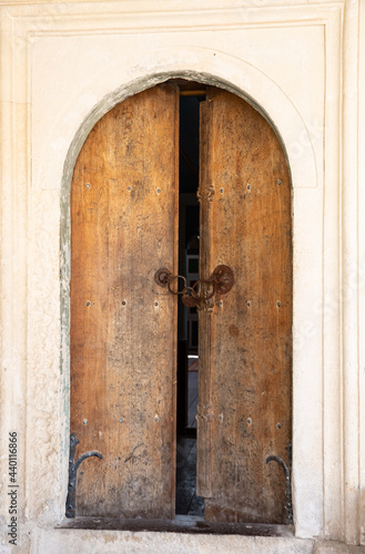 Wallpaper Mural Antique wooden doors with lock and iron handrails entrance to an ancient stone building . Torontodigital.ca