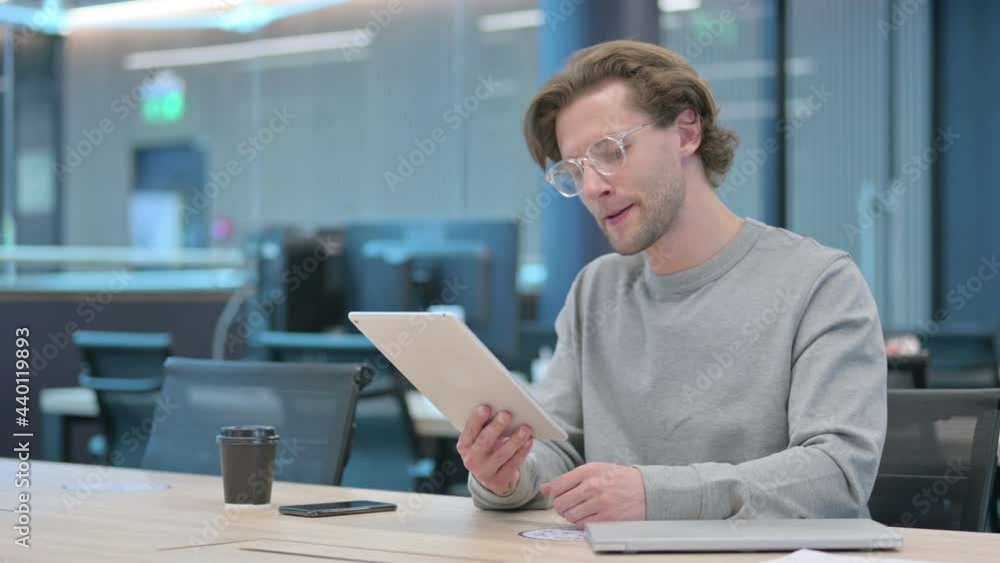 Young Businessman Reacting to Loss on Tablet Young Businessman Reacting to Loss on Tablet