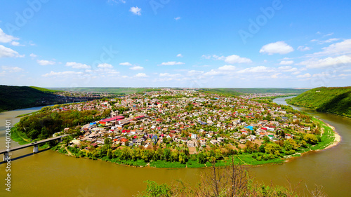 Wide angle landscape view of Zalishchyky town and canyon with Dnister River. Spring sunny landscape. Ternopil region, Ukraine. Nature and travel concept photo