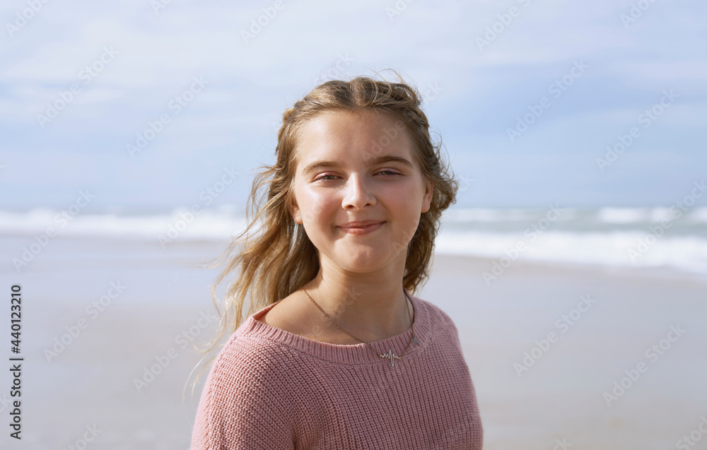Portrait of teenage girl standing on beach Portrait of teenage girl standing on beach
