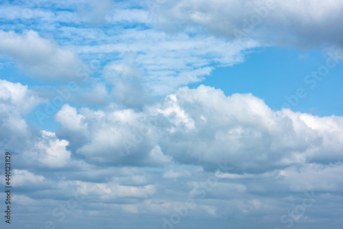 Fluffy white clouds on background of blue sky.