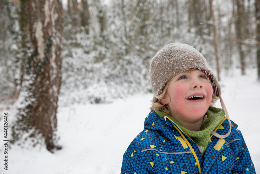 Boy looking up during winter Boy looking up during winter