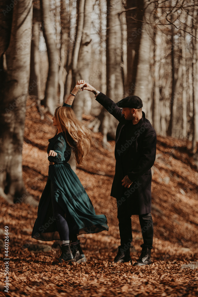 Couple dancing in forest during autumn Couple dancing in forest during autumn