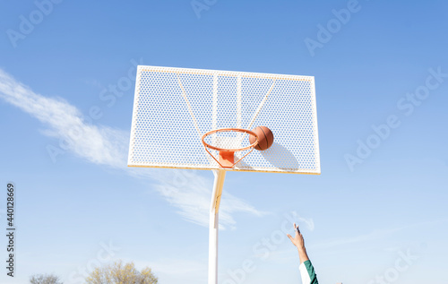 Young man playing basketball on court photo