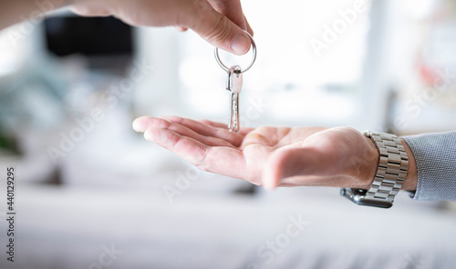 Hand handing over house keys photo