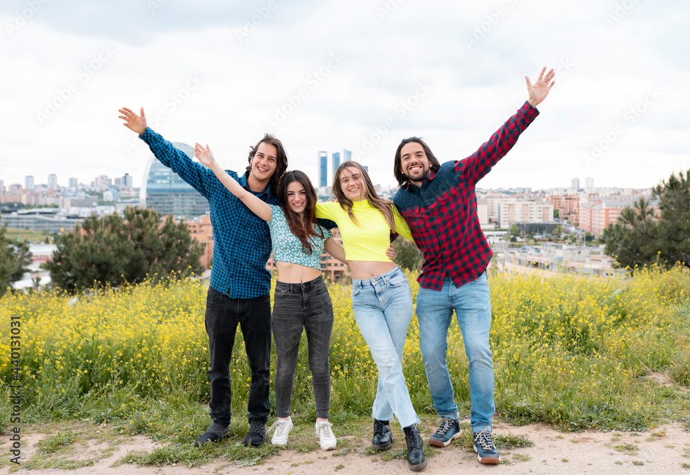 Male and female friends enjoying while standing in nature Male and female friends enjoying while standing in nature