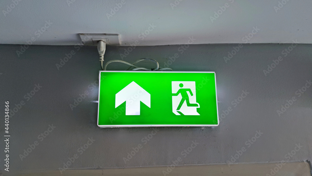 Fire warning exit with arrow symbol sign box light LED green color in the dark for doorway or Emergency Exit. Fire warning exit with arrow symbol sign box light LED green color in the dark for doorway or Emergency Exit.