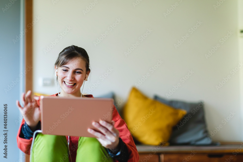 Beautiful young woman using digital tablet at home Beautiful young woman using digital tablet at home