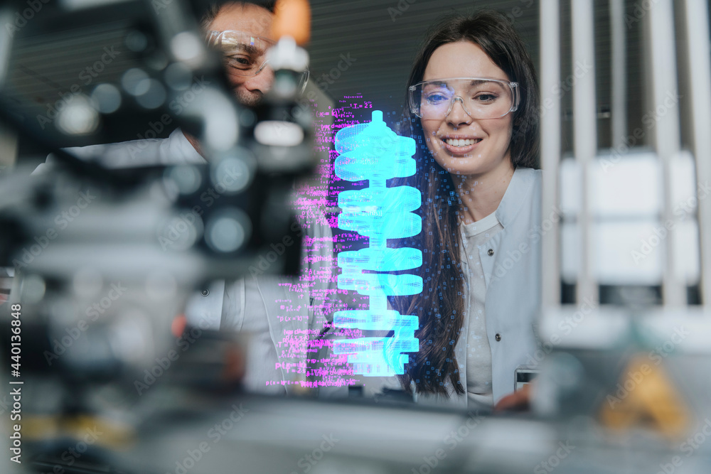 © Infinite Lux/Westend61 - Smiling female and male engineers examining futuristic automation at laboratory