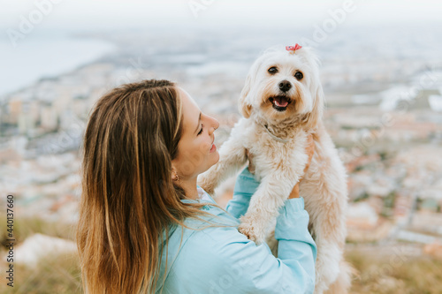 Mid adult woman looking while holding pet photo