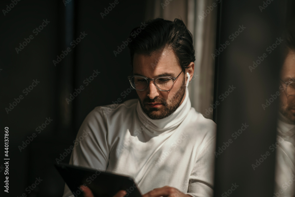 Male professional using digital tablet at home Male professional using digital tablet at home