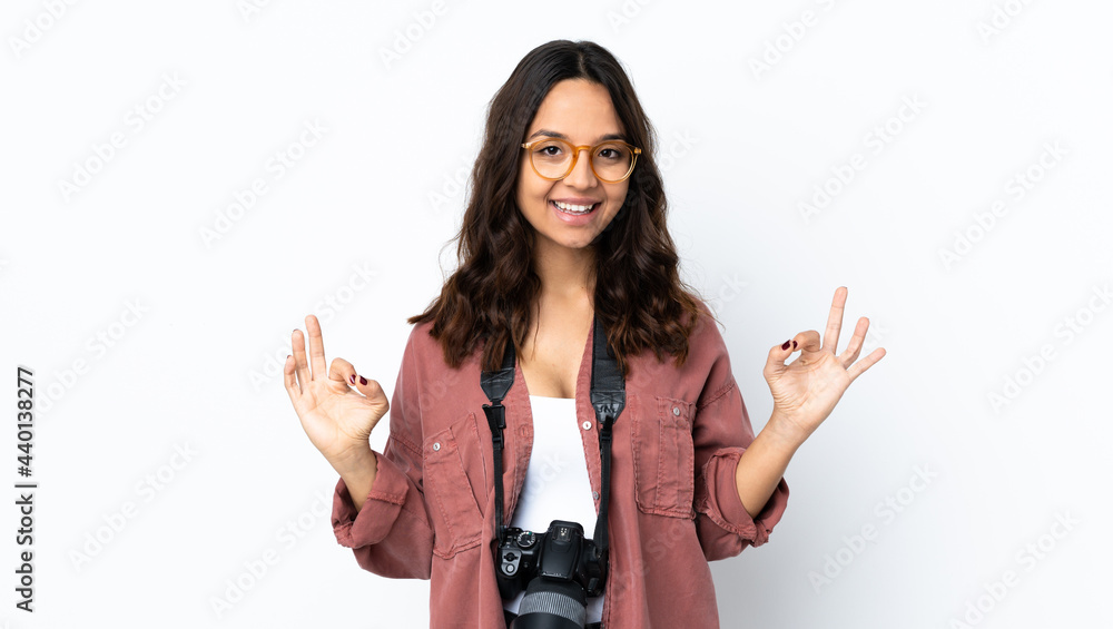 Young photographer woman over isolated white background showing ok sign with two hands Young photographer woman over isolated white background showing ok sign with two hands