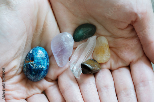 Hands holding colorful crystals