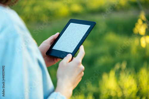 Mid adult woman reading e-book photo