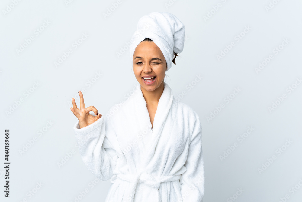 Young woman in bathrobe over isolated white background showing ok sign with fingers Young woman in bathrobe over isolated white background showing ok sign with fingers