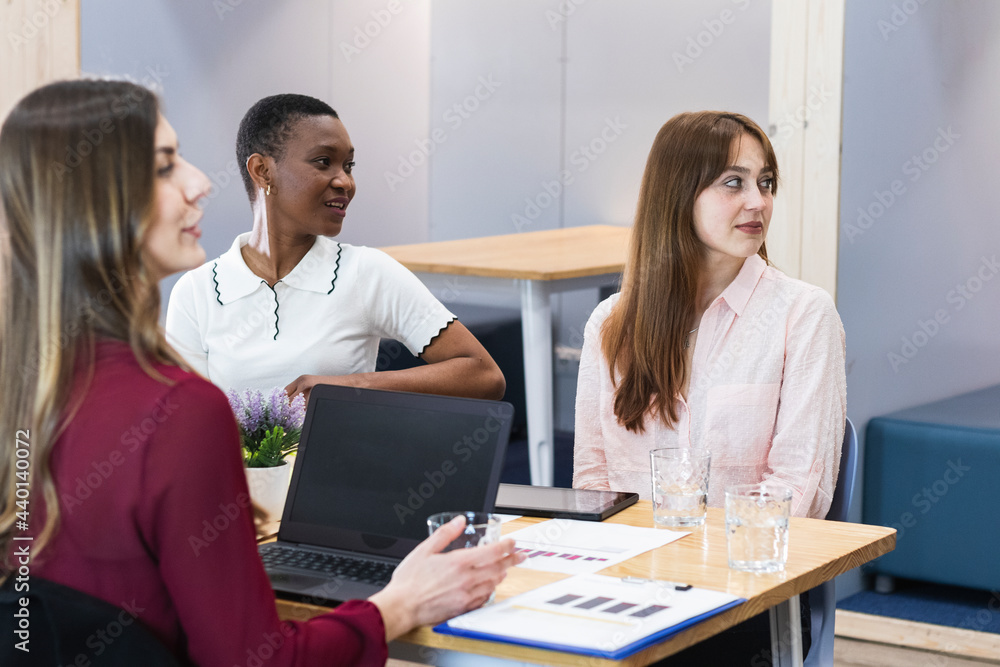 Female entrepreneurs looking away in meeting at office Female entrepreneurs looking away in meeting at office