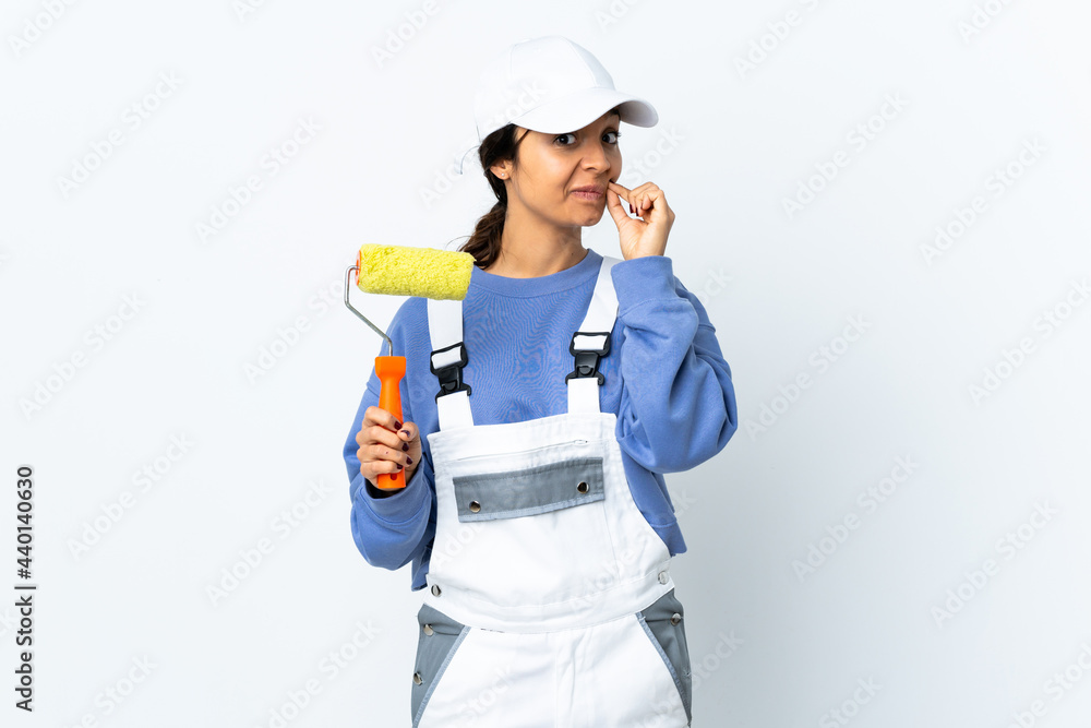 Painter woman over isolated white background showing a sign of silence gesture Painter woman over isolated white background showing a sign of silence gesture