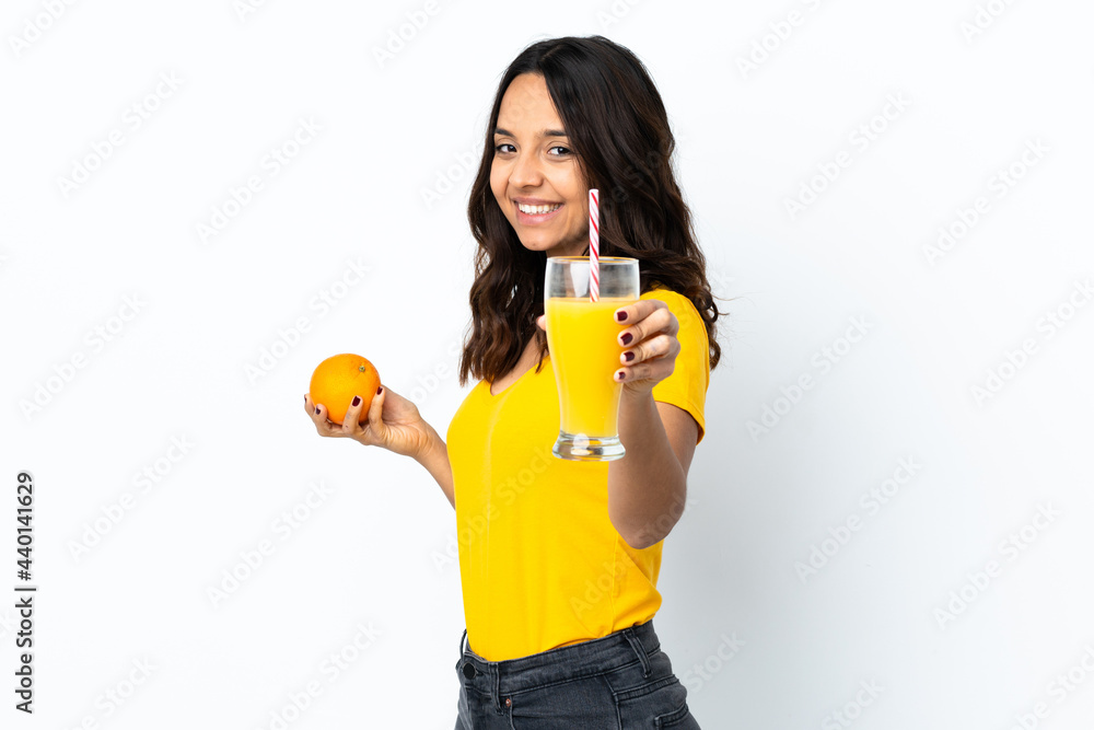 Young woman over isolated white background holding an orange and an orange juice Young woman over isolated white background holding an orange and an orange juice