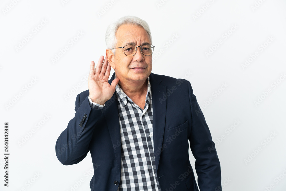 Middle age Brazilian man isolated on white background listening to something by putting hand on the ear Middle age Brazilian man isolated on white background listening to something by putting hand on the ear