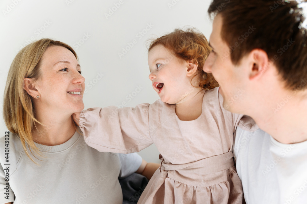 Cute girl and father looking at smiling mother at home Cute girl and father looking at smiling mother at home