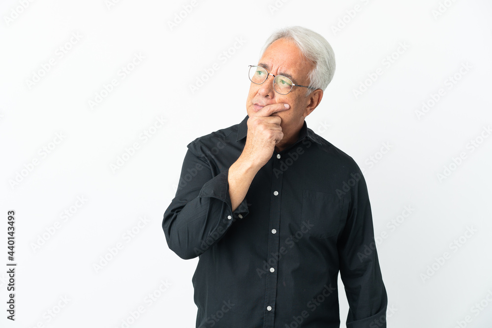 Middle age Brazilian man isolated on white background having doubts and with confuse face expression Middle age Brazilian man isolated on white background having doubts and with confuse face expression