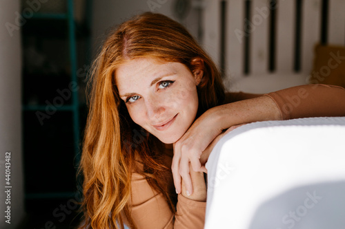 Attractive redhead woman at home photo