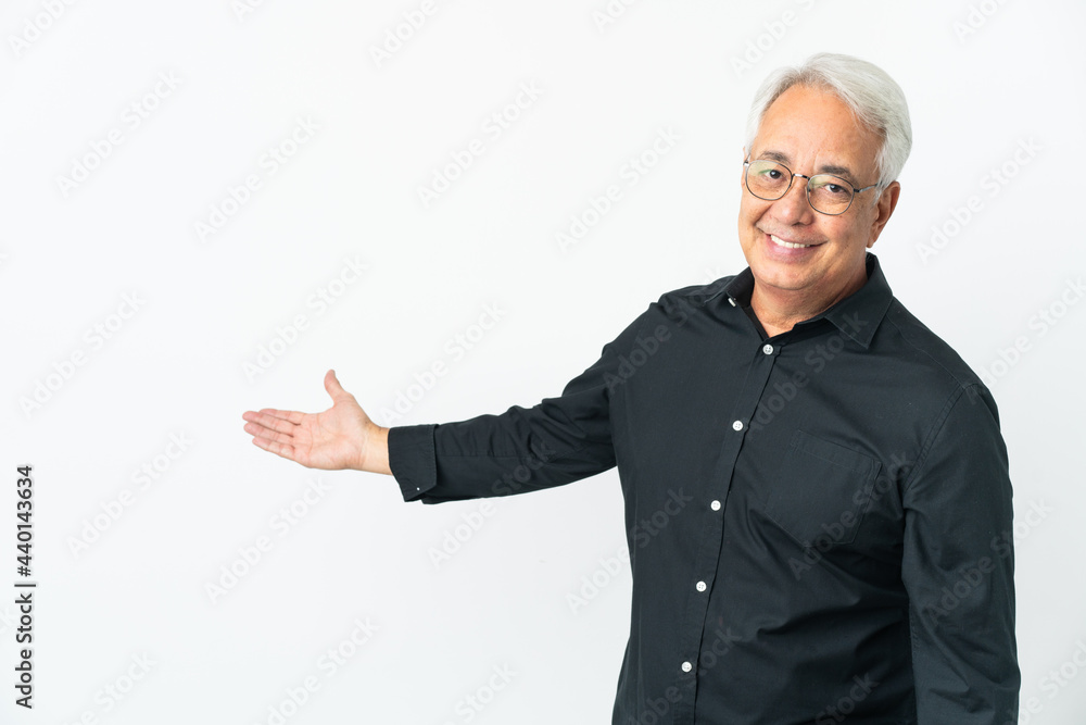 Middle age Brazilian man isolated on white background extending hands to the side for inviting to come Middle age Brazilian man isolated on white background extending hands to the side for inviting to come