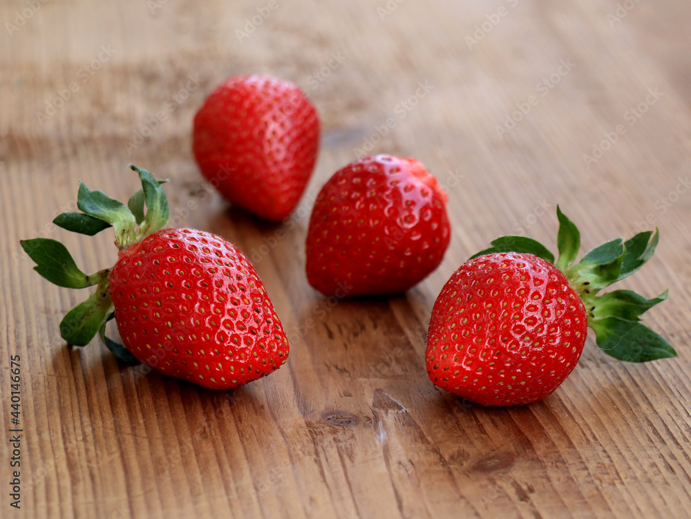 Ripe strawberries from garden on wooden background