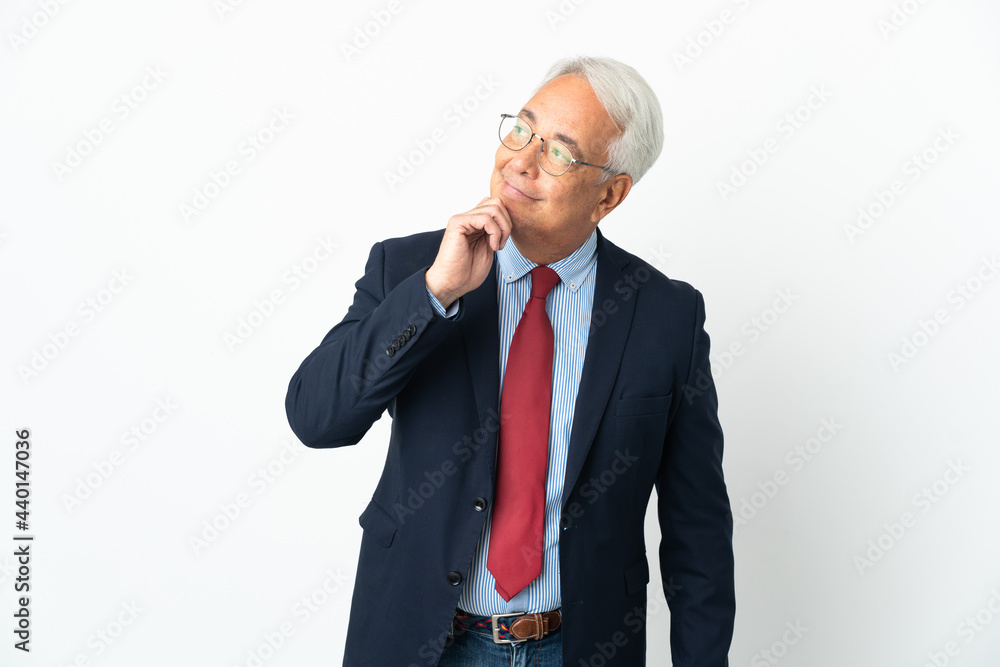 Middle age Brazilian business man isolated on white background and looking up