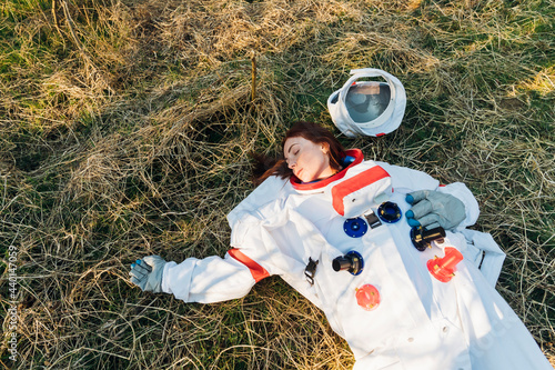 Young fainted astronaut on forest land photo