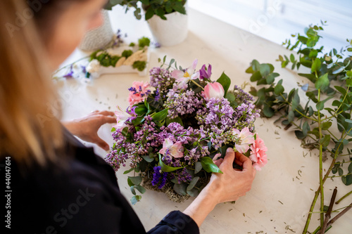 Female florist with flower arrangement at workshop photo