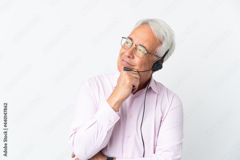 Telemarketer Middle age man working with a headset isolated on white background having doubts
