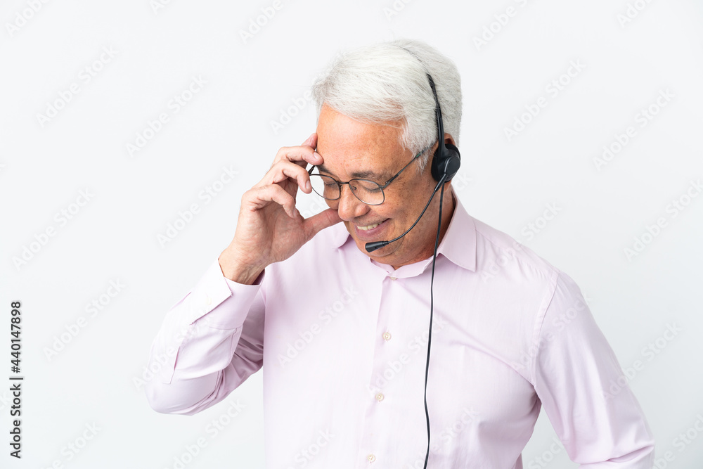 Telemarketer Middle age man working with a headset isolated on white background laughing Telemarketer Middle age man working with a headset isolated on white background laughing