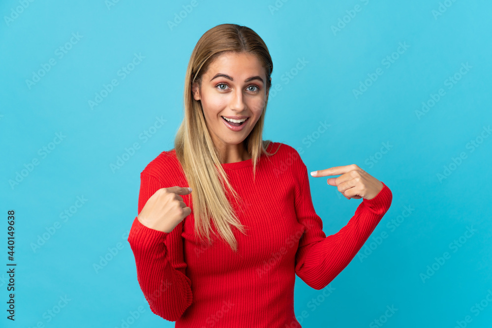 Young blonde woman isolated on blue background with surprise facial expression Young blonde woman isolated on blue background with surprise facial expression
