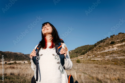 Serene woman standing below sky photo