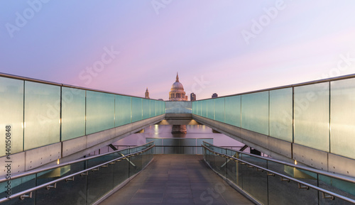 UK, England, London, Diminishing perspective of Millennium Bridge at dawn with Saint Pauls Cathedral in background photo