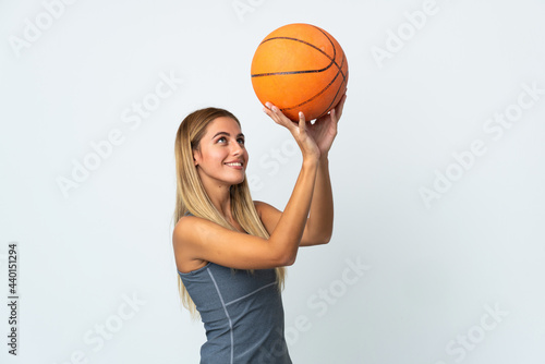 Young student woman isolated on white background playing basketball