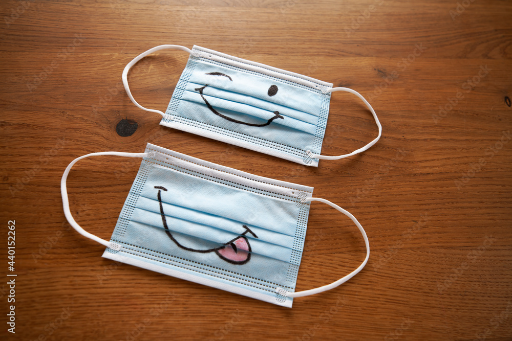 Face masks with smiley drawing on wood Face masks with smiley drawing on wood