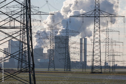 Germany, North Rhine Westphalia, Niederaussem, Electricity pylons near lignite power station photo