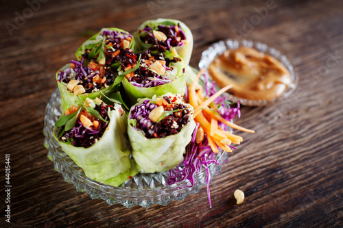 Cabbage rolls with black rice, sesame seeds, carrot and red cabbage