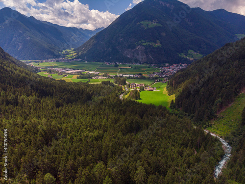 Italy, South Tyrol, Sand in Taufers, Aerial view of town in forested Tauferer Ahrntal valley photo