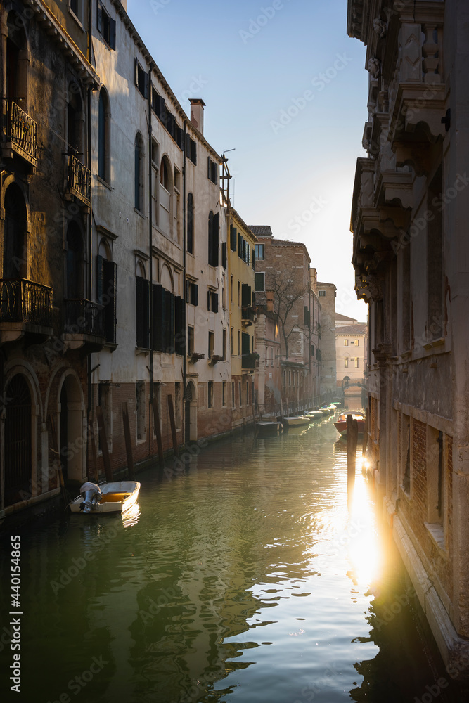 Italy, Veneto, Venice, Old houses along narrow city canal at dusk Italy, Veneto, Venice, Old houses along narrow city canal at dusk