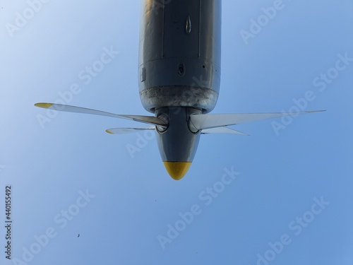 Airplane propeller against the blue sky. The aircraft engine is muted.