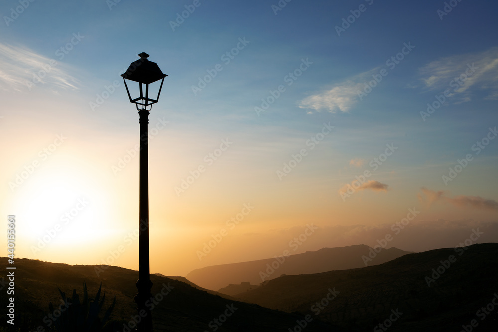 Lantern in front of mountain and sky during sunset Lantern in front of mountain and sky during sunset