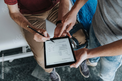Patient digitally signing form by physiotherapist in practice