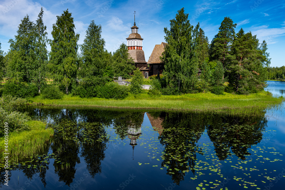Wooden church reflecting in shiny lake Wooden church reflecting in shiny lake