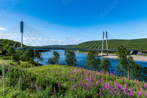 Sami Bridge stretching over Tana river in summer photo