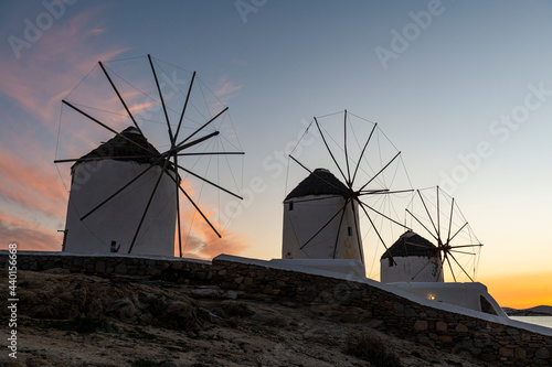 Greece, Mykonos, Horta, Row of windmills at sunset photo